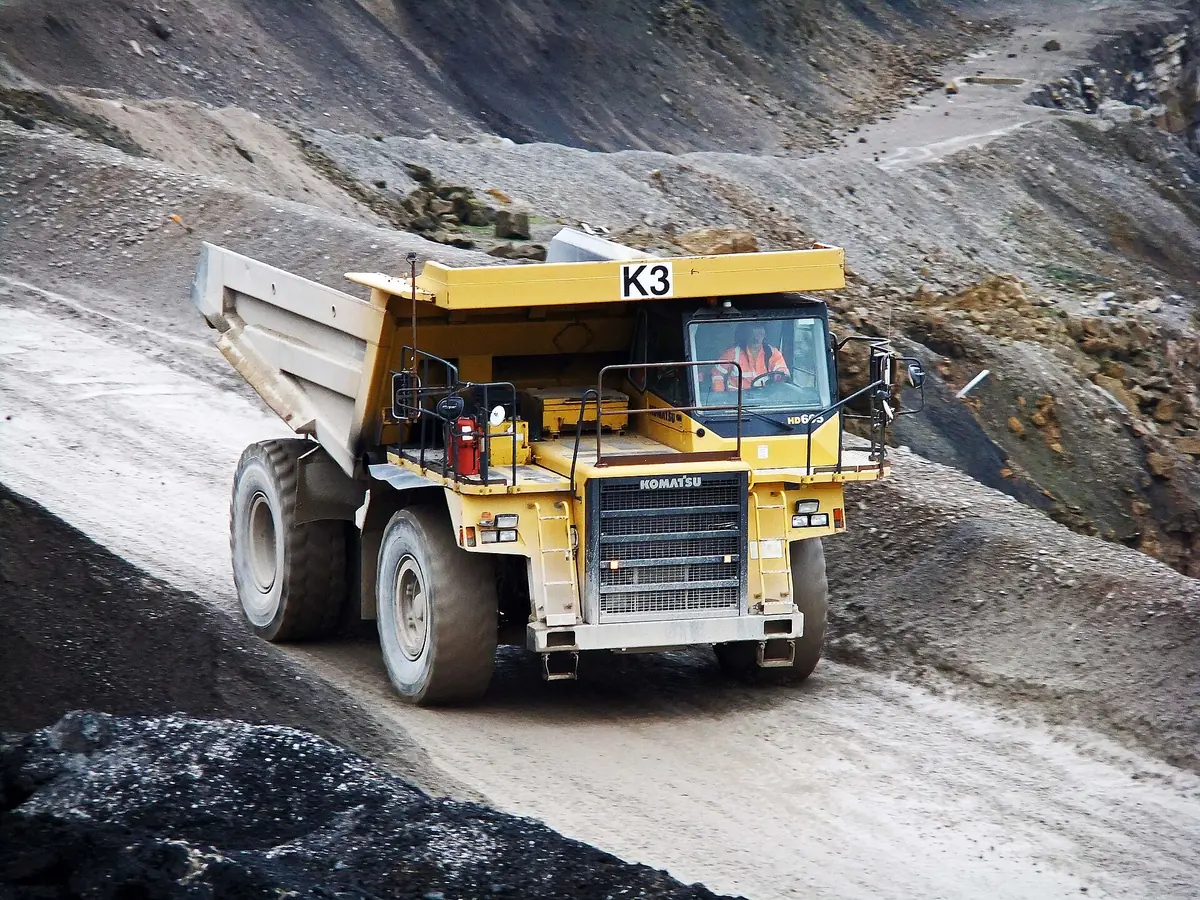 An articulated dump truck working a quarry face